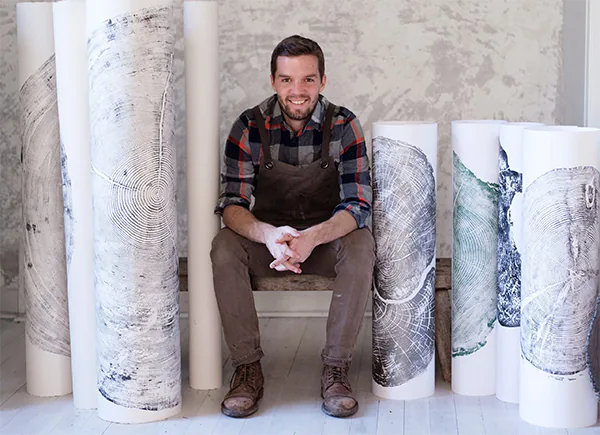 Erik Linton Surrounded by His Artworks